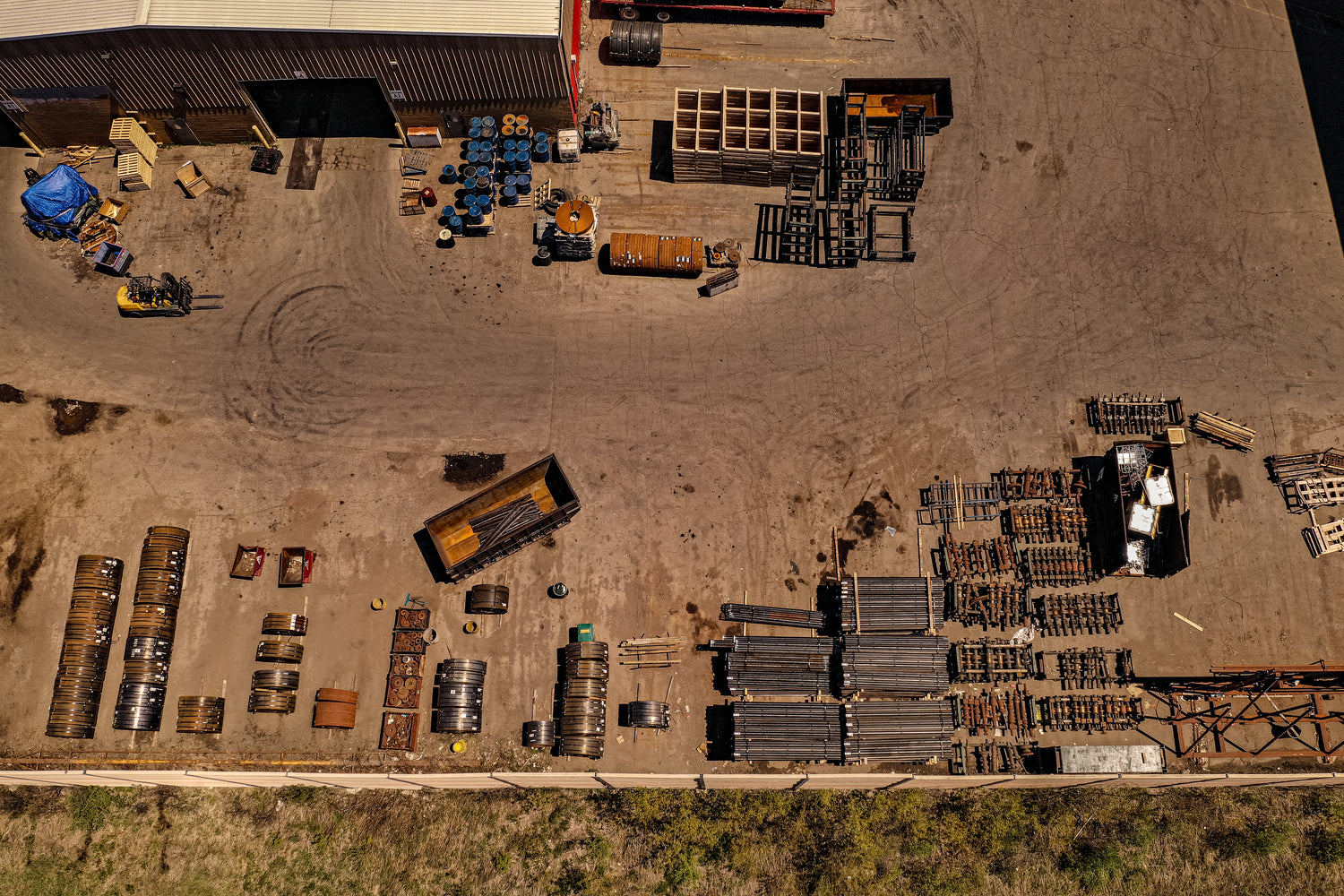 Aerial view of an industrial area with various storage containers and equipment.