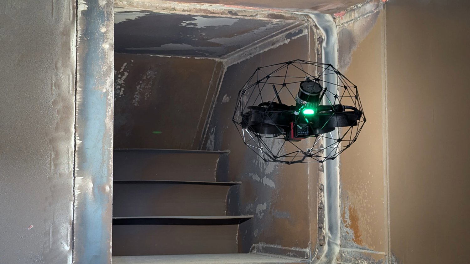 Elios-3 with a green light inside a confined space