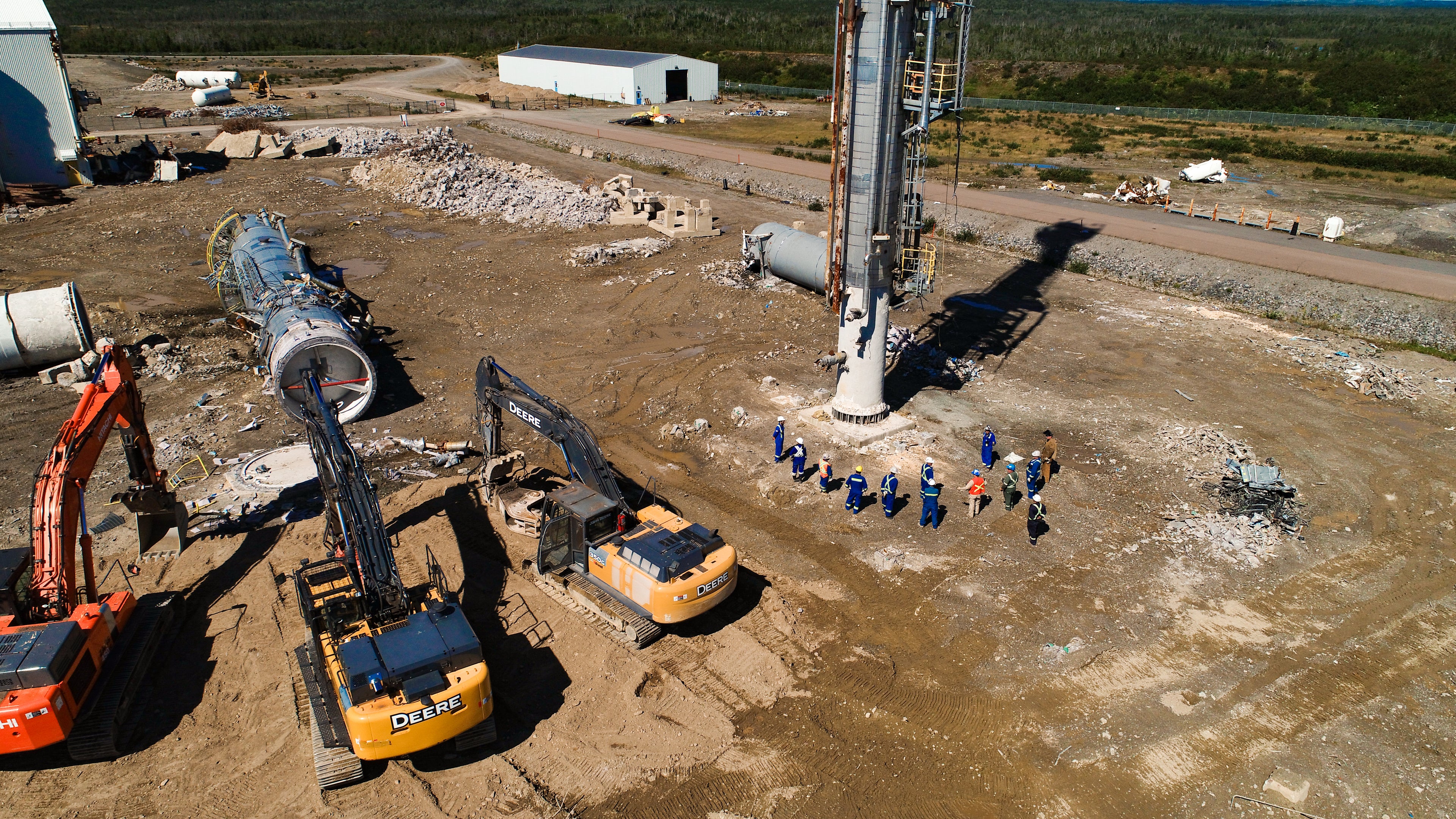 Construction site with excavators and workers in a rural area