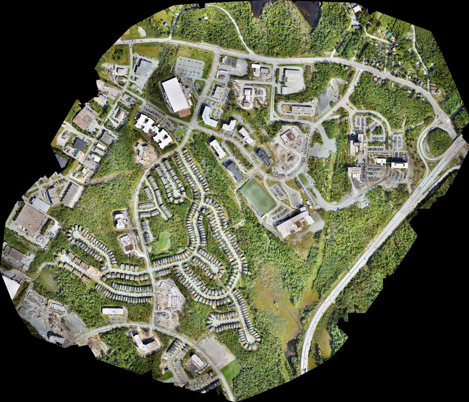 Aerial view of a suburban area model with houses and roads.