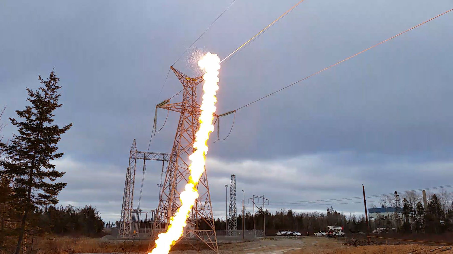Flaming volt near power lines with a cloudy sky