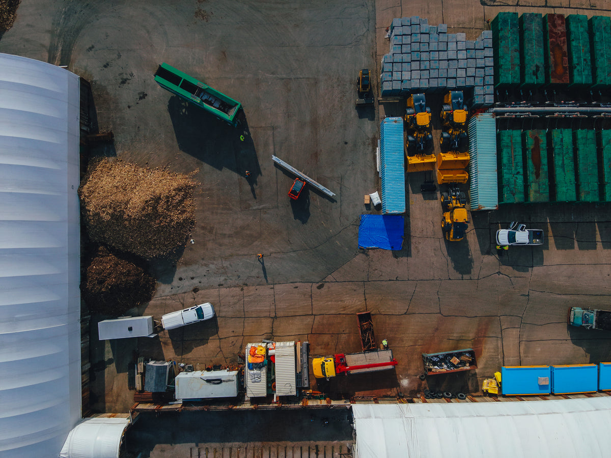 Aerial view of a warehouse or industrial area with various equipment and vehicles.