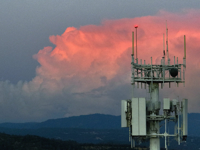 Top of utility asset seen head on from a drone, a light blue and pink cloudy sky in the background.